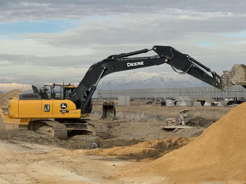 Excavation crew moving dirt around on-site in Utah.
